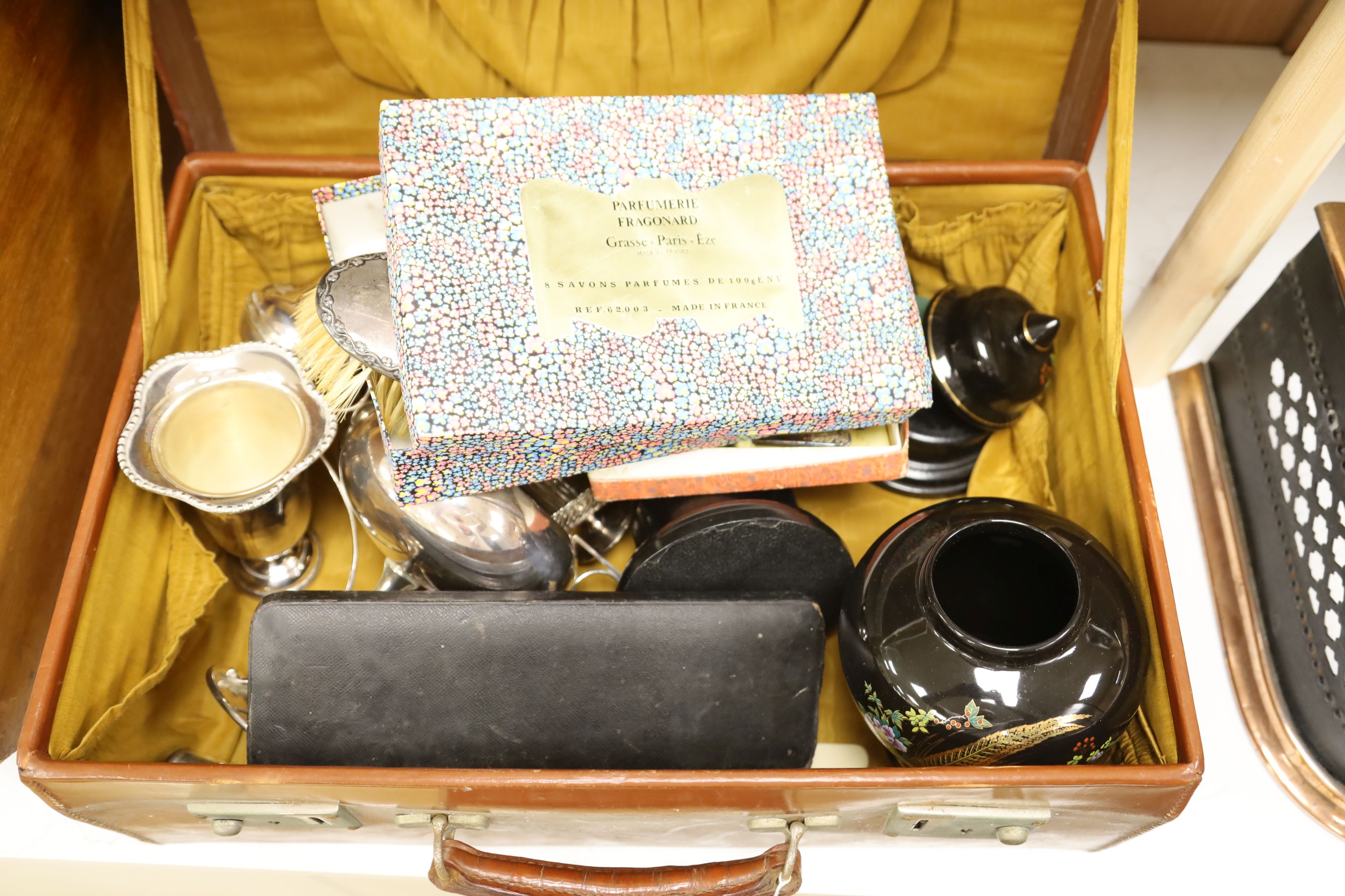 A leather case with collectables including a silver cigarette case, plated wares, a vase etc.